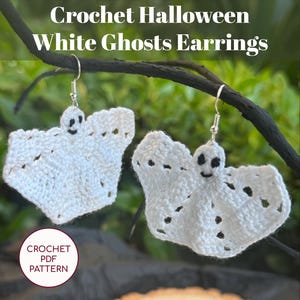 May include: A pair of white crochet ghost earrings with black facial details and small holes. The earrings hang from silver hooks. The image includes the text "Crochet Halloween White Ghosts Earrings" and "CROCHET PDF PATTERN".