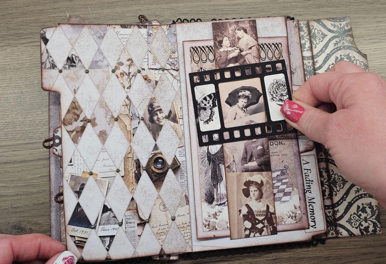 May include: Open scrapbook with vintage-style pages. The left side features a diamond pattern with old photos and ephemera. The right side displays more photos and the text "A Fading Memory." A film strip-shaped photo holder is being held.