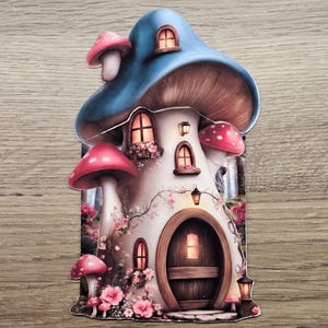 Blue mushroom cottage hidden note design printed and fully assembled, shown as a woodland journal insert on a wooden background.