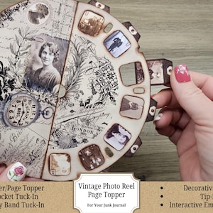 May include: A vintage-style photo reel page topper with a sepia-toned design. The circular design features a portrait, a pocket watch, and floral and map elements. The reel includes small photo inserts and is held by a hand. The text reads "Vintage Photo Reel Page Topper".