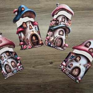 Four mushroom cottage hidden notes shown open with the tops lifted to reveal lined inserts, displayed on a wooden background for junk journal crafting.