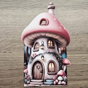Pink mushroom cottage hidden note design printed and fully assembled, shown as a journal insert on a wooden background.