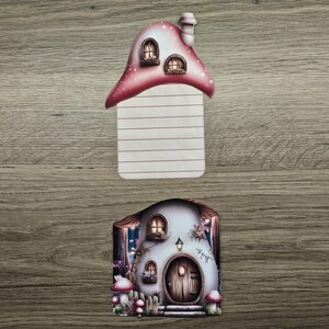 Pink mushroom cottage hidden note with the lined insert removed and displayed above the matching house design on a wooden background.
