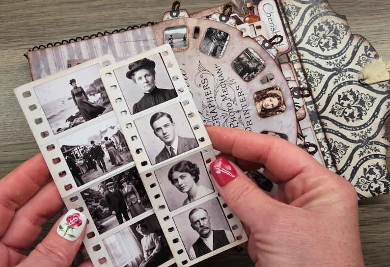 May include: A vintage-style scrapbook with black and white photographs and decorative paper. The scrapbook features a film strip with portraits and a circular design with the text "Photographers Photo Mechanics Printers".