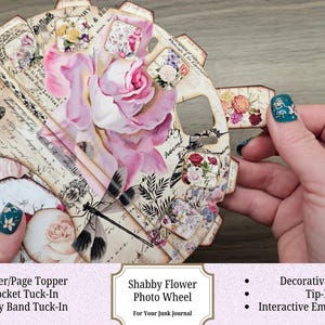 May include: A handmade Shabby Flower Photo Wheel for junk journals. The wheel features a large pink rose, floral accents, and vintage script. Includes cover/page topper, pocket tuck-in, belly band tuck-in, decorative insert, tip-in, and interactive embellishment.