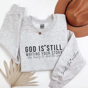 Inspirational Christian Crewneck Sweatshirt: &quot;God Is Still Writing Your Story&quot;