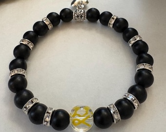 Strength & Hope Bracelet – Yellow Awareness Ribbon, Matte Black Onyx, Heart Charm, Silver Rhinestone Spacers, Bone Cancer Gift Jewelry