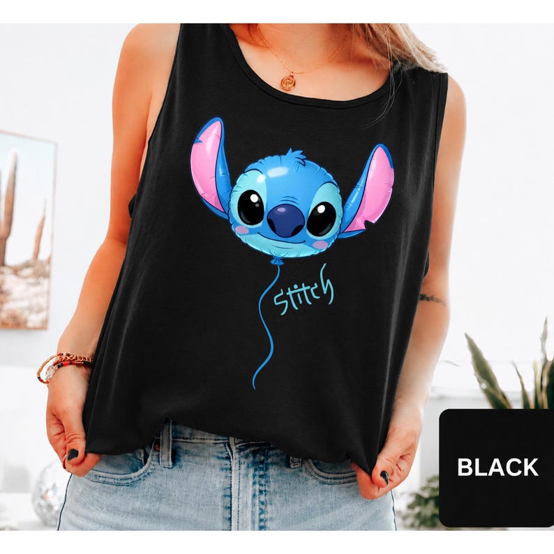 May include: A black sleeveless tank top featuring a graphic of the character Stitch designed as a blue balloon with large ears and black eyes. Below the balloon, the word stitch is written in a light blue cursive font on the front of the garment.