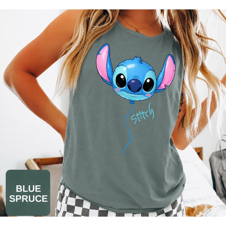 May include: A blue spruce colored sleeveless tank top featuring a graphic of the character Stitch designed as a blue balloon with large ears and black eyes. Below the balloon, the name Stitch is written in a light blue cursive script font.