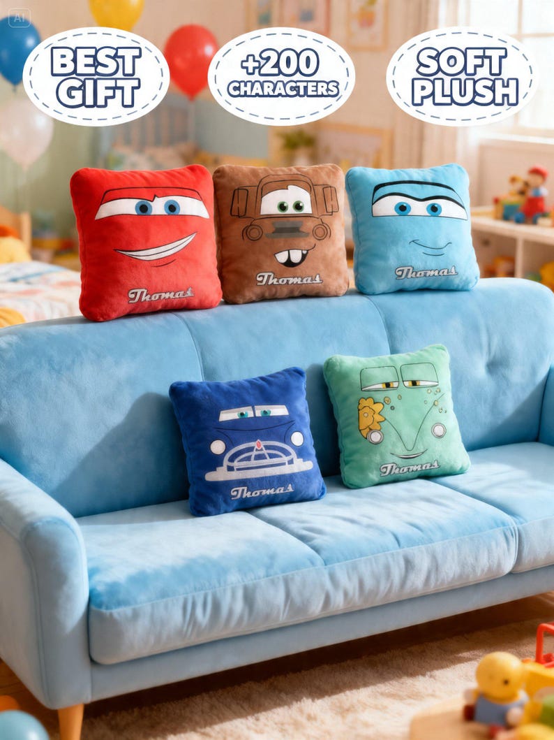 May include: A collection of plush pillows in various colors, each featuring a cartoon car face. The pillows are red, brown, blue, and green, with the name "Thomas" embroidered on each. They are arranged on a light blue sofa.