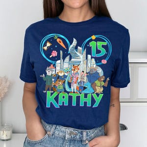 May include: A white ceramic mug with a black handle and the text "But First, Coffee" in a handwritten style. The mug is on a white surface. The mug is approximately 4 inches tall.