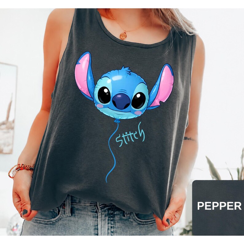 May include: A dark gray sleeveless tank top featuring a graphic of the character Stitch designed as a blue balloon with large pink-lined ears and black eyes. Below the balloon, the word Stitch is written in a light blue cursive script font.