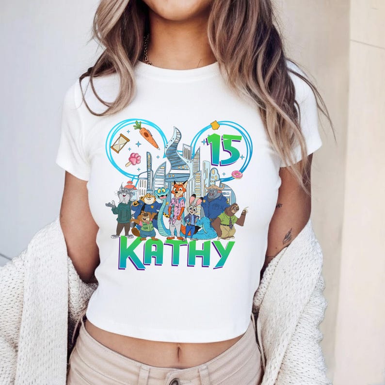 May include: A white ceramic mug with a black handle and the text "But First, Coffee" in a bold, black font. The mug is set against a blurred background, suggesting a cozy setting.