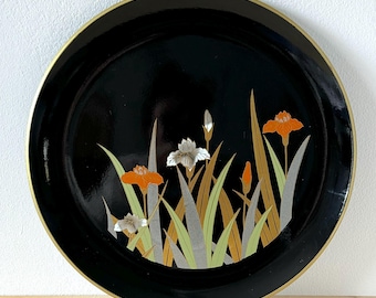 May include: Black lacquer tray with a gold rim and a floral design featuring white and orange flowers on a black background.