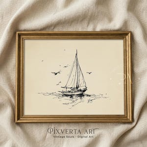 May include: A framed wall art print featuring a black ink sketch of a sailboat on a cream-colored background. The drawing depicts a single-masted boat on water with several birds flying nearby. The artwork is enclosed in a metallic gold frame.