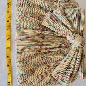 Measurement photo showing Loeffler Randall Rayne clutch height with tape measure, approximately 7 inches tall.