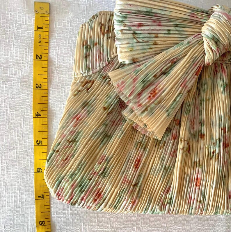 Measurement photo showing Loeffler Randall Rayne clutch width with tape measure, approximately 11.25 inches wide.
