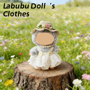 May include: A plush doll wearing a straw hat adorned with a pink rose and a white lace dress with daisy accents. The doll has a pearl necklace and is standing on a tree stump. The text "Labubu Doll 's Clothes" is at the top.
