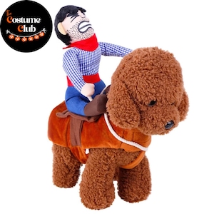 May include: A brown plush dog costume with a cowboy rider. The cowboy wears a blue and white checkered shirt, blue pants, and a red scarf. The dog costume has a brown saddle and is designed for pets. The Costume Club logo is in the upper left corner.