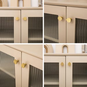 May include: A four-panel image of a beige cabinet with glass doors. Each door has a gold-coloured knob. The glass panels have a vertical ribbed texture. The cabinet's design is simple and modern, suitable for storage.