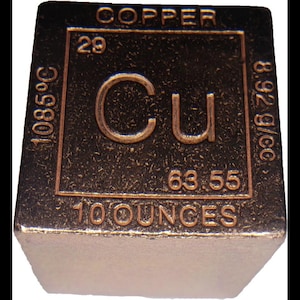 May include: A copper cube with the periodic table symbol Cu. The top surface features the word "COPPER", the atomic number 29, and the atomic mass 63.55. It weighs 10 ounces and has a melting point of 1085°C. The density is 8.92 g/cc.