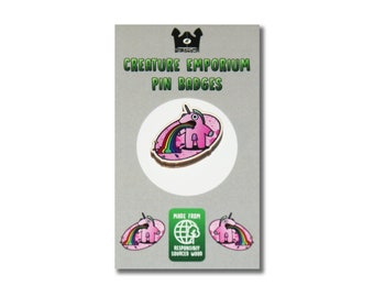 May include: A pink unicorn pin badge with a rainbow coming out of its mouth. The badge is made from responsibly sourced wood and is part of the Creature Emporium Pin Badges collection.