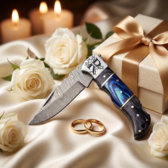 Handmade personalized Damascus folding knife — the 'handmade' claim on Damascus steel feels credible and the craft details elevate it above generic laser-engraved gifts.