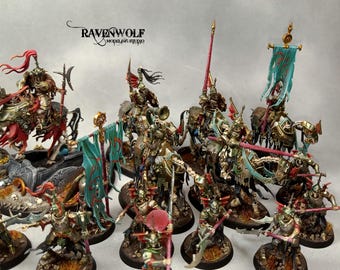 May include: A collection of intricately painted miniature figurines of mounted knights and foot soldiers. The knights are on horseback, and the soldiers are on foot, all in detailed armor with various weapons and banners. The color palette includes gold, red, and teal.