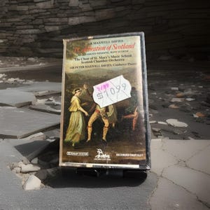 May include: A vintage cassette tape of Peter Maxwell Davies' "Celebration of Scotland" featuring "An Orkney Wedding, With Sunrise." The cover art depicts a historical scene. The tape has a price tag of $10.99 and is labeled "Recorded Digitally."
