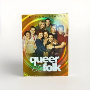 May include: A DVD box set of "Queer as Folk: The Final Season Collector's Edition" featuring a group of people. The cover has a gold and rainbow gradient background with the show's title in white.