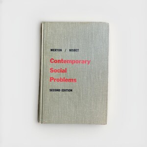 May include: A hardcover book titled "Contemporary Social Problems" with the authors Merton / Nisbet and "Second Edition" printed on the cover. The book has a light gray textured cover with red text.