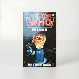 May include: A vintage paperback book titled "Doctor Who: The Savages" with a dark cover featuring illustrations of characters and a blue police box. The book has the number 109 on the top right corner and the author's name, Ian Stuart Black, at the bottom.