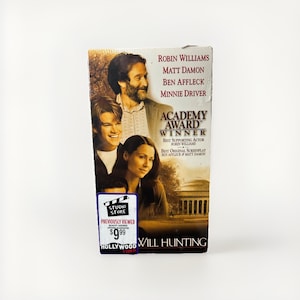 May include: A VHS tape for the movie "Will Hunting" featuring Robin Williams, Matt Damon, Ben Affleck, and Minnie Driver. The tape is labeled "Academy Award Winner" and includes the Studio Store sticker.