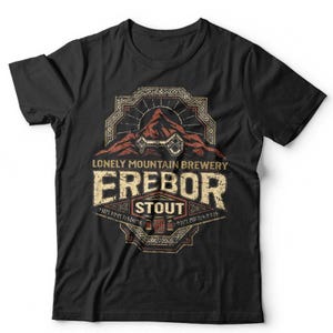 May include: Black t-shirt featuring a distressed graphic design. The design includes the text "Lonely Mountain Brewery Erebor Stout" with a mountain and key illustration in shades of brown and beige. The shirt is a crew neck.