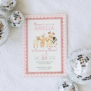 May include: A pink and white gingham-bordered invitation with the text "Three-i-e-i-o AMELIA is turning three!" and farm animal illustrations. The invitation is surrounded by silver disco balls.