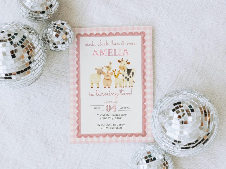 May include: A pink and white gingham-bordered invitation with the text "oink, cluck, baa & moo AMELIA is turning two!" features farm animal illustrations. The invitation includes event details and RSVP information. Silver disco balls are scattered around the invitation.