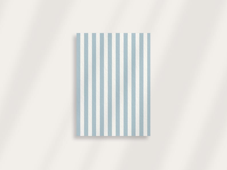 May include: A rectangular object with a vertical striped pattern in light blue and white. The stripes are evenly spaced and run the entire length of the object. The background is a plain, off-white color.