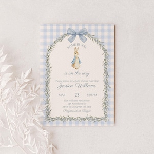May include: A baby shower invitation with a blue gingham background and a watercolor illustration of Peter Rabbit. The invitation includes the text "SOME BUNNY is on the way" and details for Jessica Williams' baby shower.