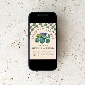 May include: A smartphone displays a birthday invitation. The invitation features a monster truck graphic with the text "BIRTHDAY DIGGER" and "SUMMIT'S THIRD". The date and time are also included. The background is a beige color with a checkered pattern.
