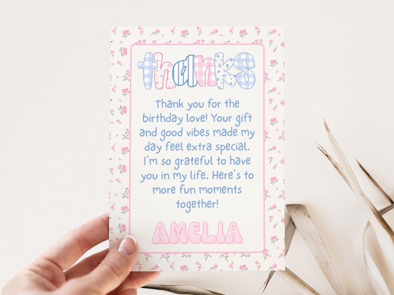 May include: A thank you card with a floral border and the word "thanks" in a playful font. The card includes a message expressing gratitude for birthday wishes and gifts, and is personalized with the name "Amelia".