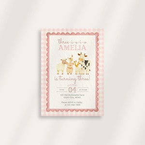 May include: A pink and white gingham-bordered invitation card. The text reads "Three-i-e-i-o Amelia is turning three!" with farm animal illustrations. The date is June 4th at 9 AM. Includes RSVP information.
