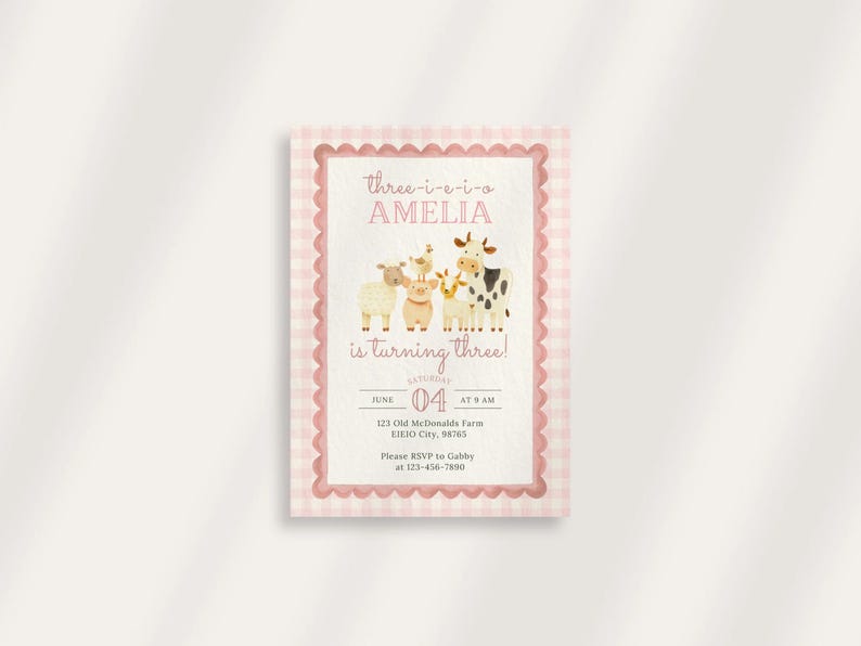 May include: A pink and white gingham-bordered invitation card. The text reads "Three-i-e-i-o Amelia is turning three!" with farm animal illustrations. The date is June 4th at 9 AM. Includes RSVP information.