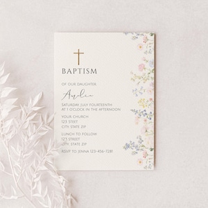May include: A baptism invitation card with a gold cross at the top and floral accents. The text reads "Baptism of our daughter" followed by the name "Avelie" in cursive. Additional text includes the date, time, church address, and RSVP information.