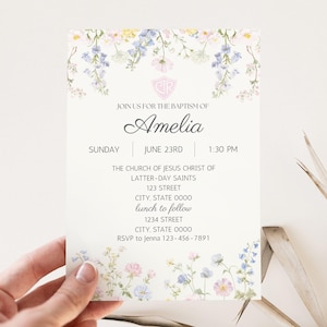 May include: Baptism invitation featuring floral watercolor designs in pastel colors. The invitation includes the name "Amelia", date, time, and location details. The text is in a classic serif font, with a decorative floral border.