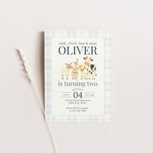 May include: A light blue plaid-patterned invitation card with the text "oink, cluck, baa & moo OLIVER is turning two". The card features illustrations of farm animals. The date is June 4th at 9 AM.