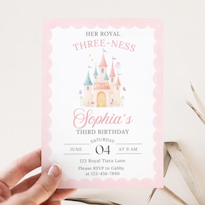 May include: A pink and white invitation card for a third birthday party. The card features a watercolor illustration of a castle and the text "HER ROYAL THREE-NESS" and "Sophia's THIRD BIRTHDAY". The date is June 04 at 9 AM.