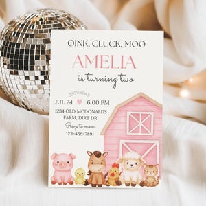 May include: A party invitation with the text "OINK, CLUCK, MOO" and "AMELIA is turning two." The invitation features a pink barn illustration and cartoon farm animals. The date and time are listed as July 24th at 6:00 PM. A disco ball is in the background.