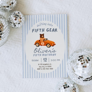 May include: A birthday invitation with a light blue striped background and the text "shifting into FIFTH GEAR". The invitation features a cartoon bear driving an orange car. The text reads "Oliver's FIFTH BIRTHDAY" with the date and time.