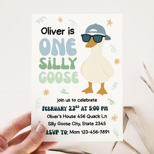May include: A birthday invitation featuring a cartoon goose wearing sunglasses and a cap. The text reads "Oliver is ONE SILLY GOOSE" with event details. The invitation is held by a hand.
