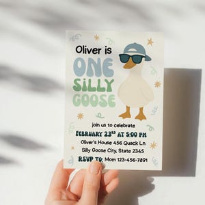 May include: A birthday invitation featuring a cartoon goose wearing sunglasses and a cap. The text reads "Oliver is One Silly Goose" with event details. The invitation is held by a hand.